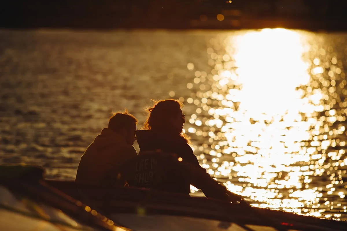Romantic couple on a boat watching the sunset